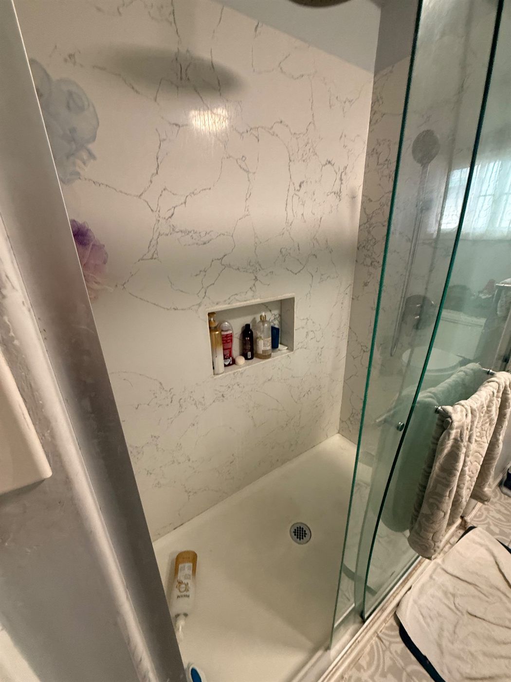 Remodeled shower with large-format slab walls
