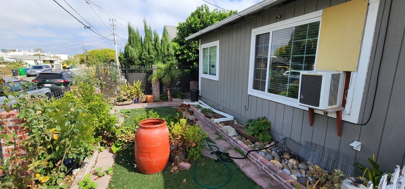 Front yard with artificial turf and planting beds